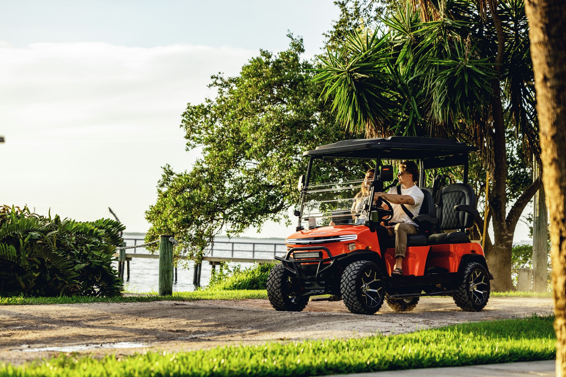 Red EZ Go gas golf cart cruising the Emerald Coast near Destin, FL